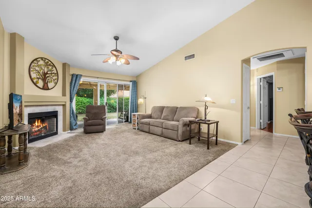 a living room with furniture a window and a fireplace