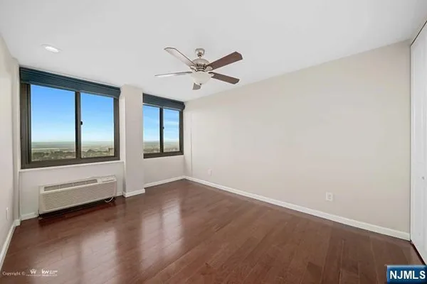 a view of a room with wooden floor