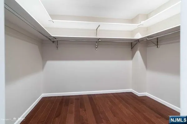 a view of a hallway with wooden floor and stairs