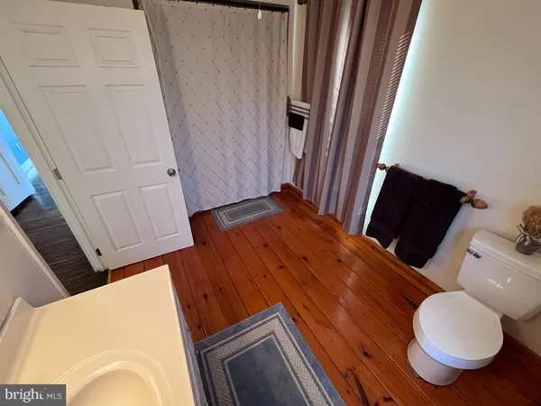 a view of an empty room and wooden floor