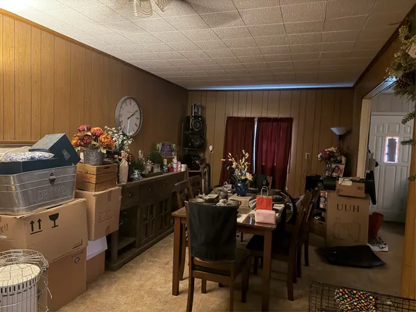 a room with furniture a chandelier and a wooden floor