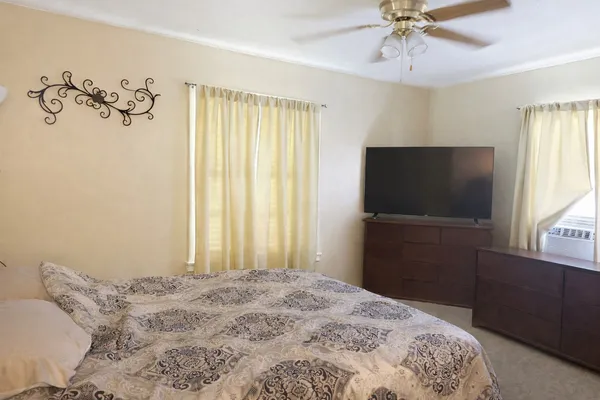 a bedroom with a bed and a flat screen tv