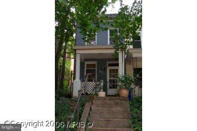 a view of a house with potted plants