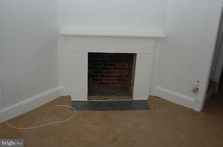 57 Todd Place Northeast Washington, DC 20002 - Photo 11 of 15 a view of a livingroom with wooden floor and a fireplace
