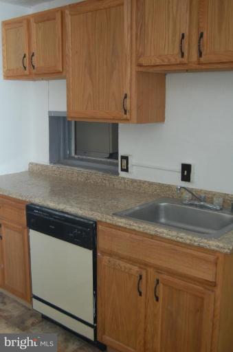 57 Todd Place Northeast Washington, DC 20002 - Photo 7 of 15 a kitchen with granite countertop cabinets and white appliances