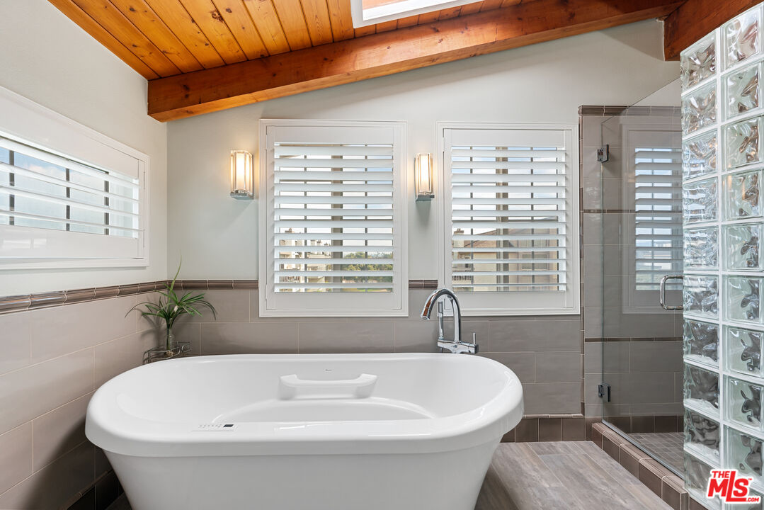 3941 Sunset Lane Oxnard, CA 93035 - Photo 13 of 24 a white bath tub sitting in a bathroom next to a window