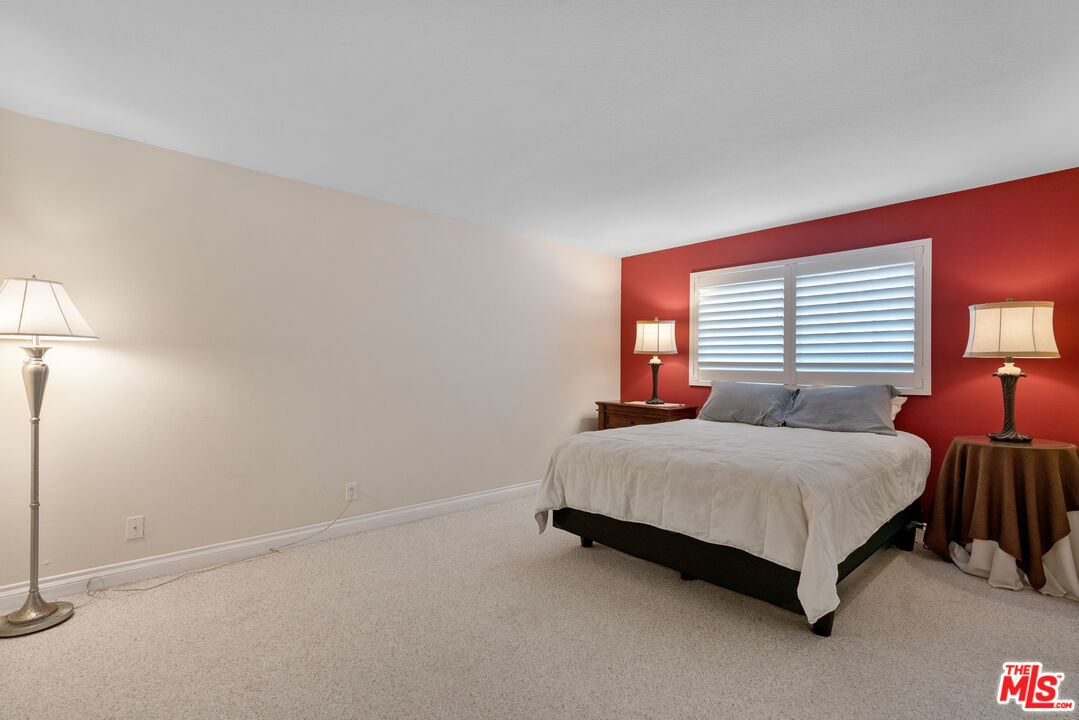 3941 Sunset Lane Oxnard, CA 93035 - Photo 16 of 24 a bedroom with a bed lamp closet and window