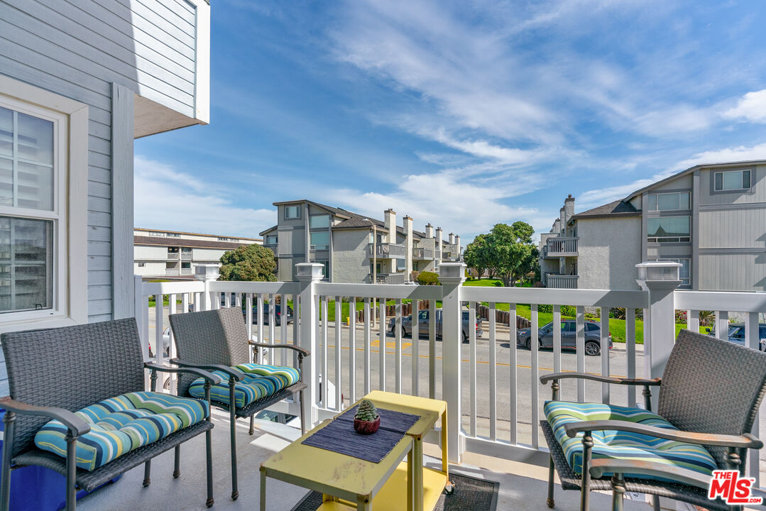 3941 Sunset Lane Oxnard, CA 93035 - Photo 23 of 24 a balcony with couple of chairs and couch