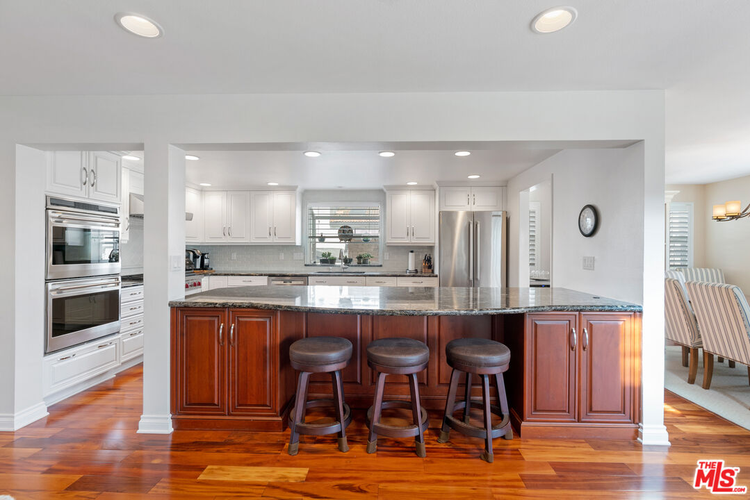 3941 Sunset Lane Oxnard, CA 93035 - Photo 5 of 24 a large kitchen with a table and chairs in it