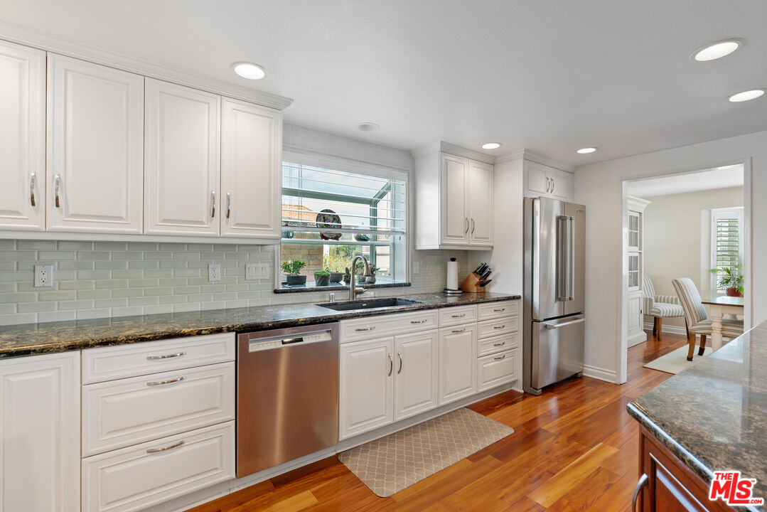 3941 Sunset Lane Oxnard, CA 93035 - Photo 7 of 24 a kitchen with stainless steel appliances granite countertop a sink and cabinets