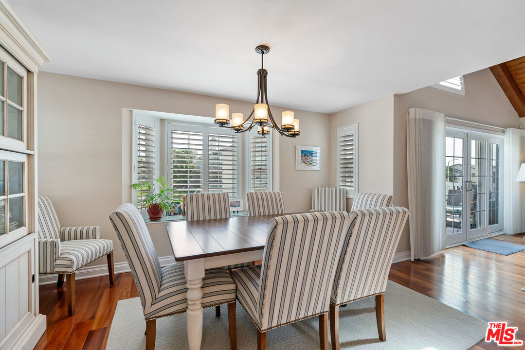 3941 Sunset Lane Oxnard, CA 93035 - Photo 8 of 24 a dining room with furniture a chandelier and wooden floor