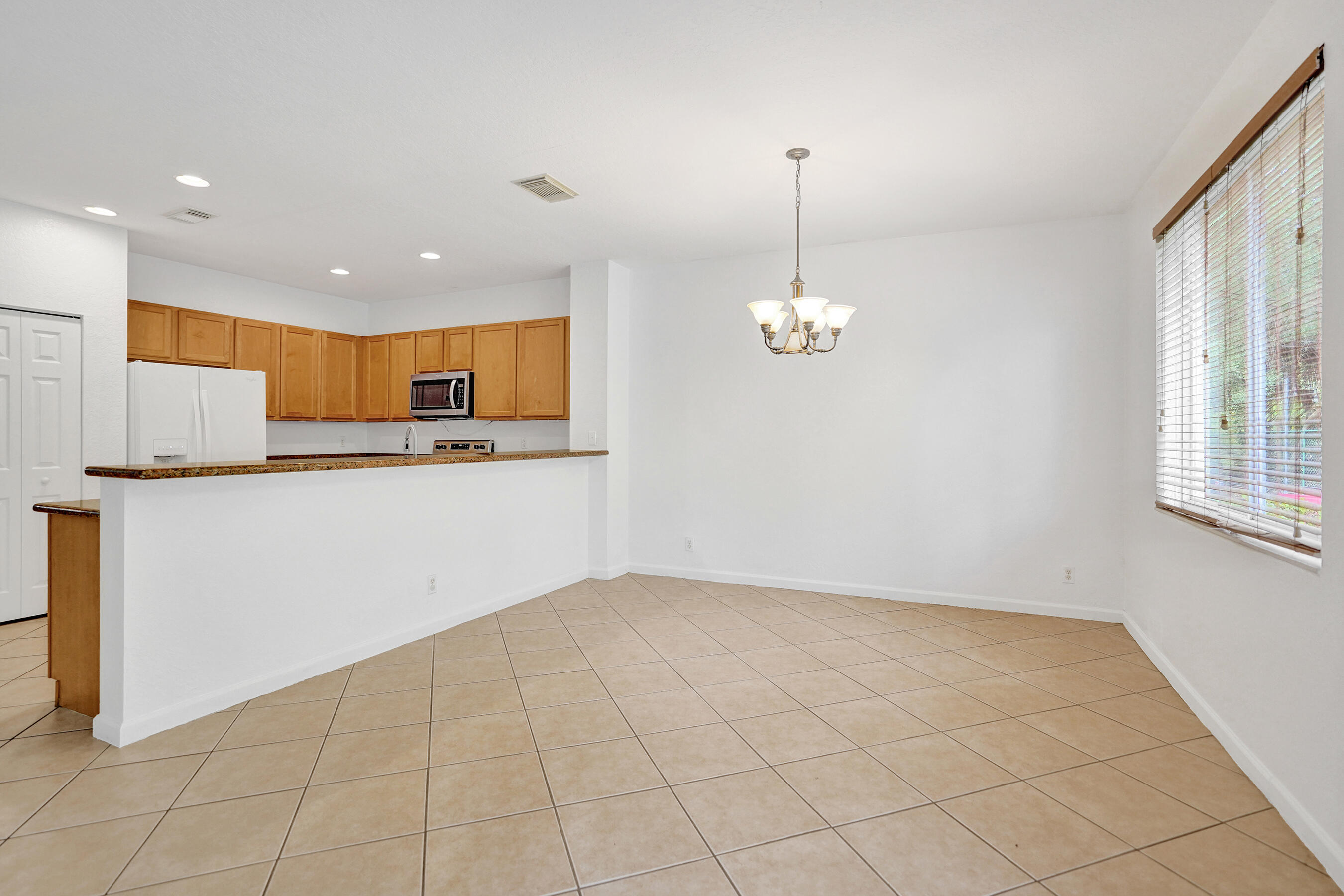 3072 North Evergreen Circle Boynton Beach, FL 33426 - Photo 15 of 55 a view of a kitchen with a stove cabinets and a wooden floor
