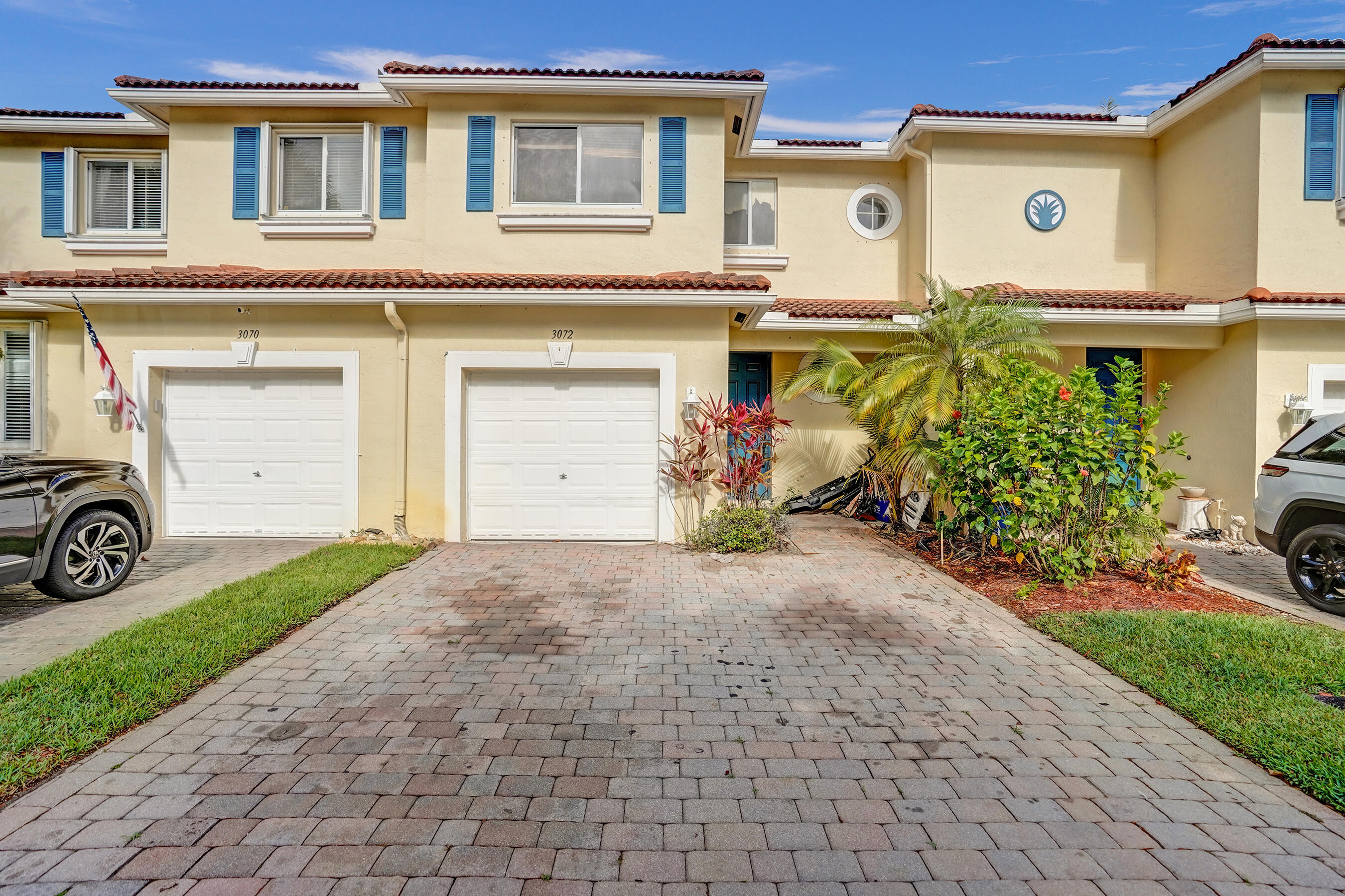 3072 North Evergreen Circle Boynton Beach, FL 33426 - Photo 2 of 55 a front view of a house with a yard and garage