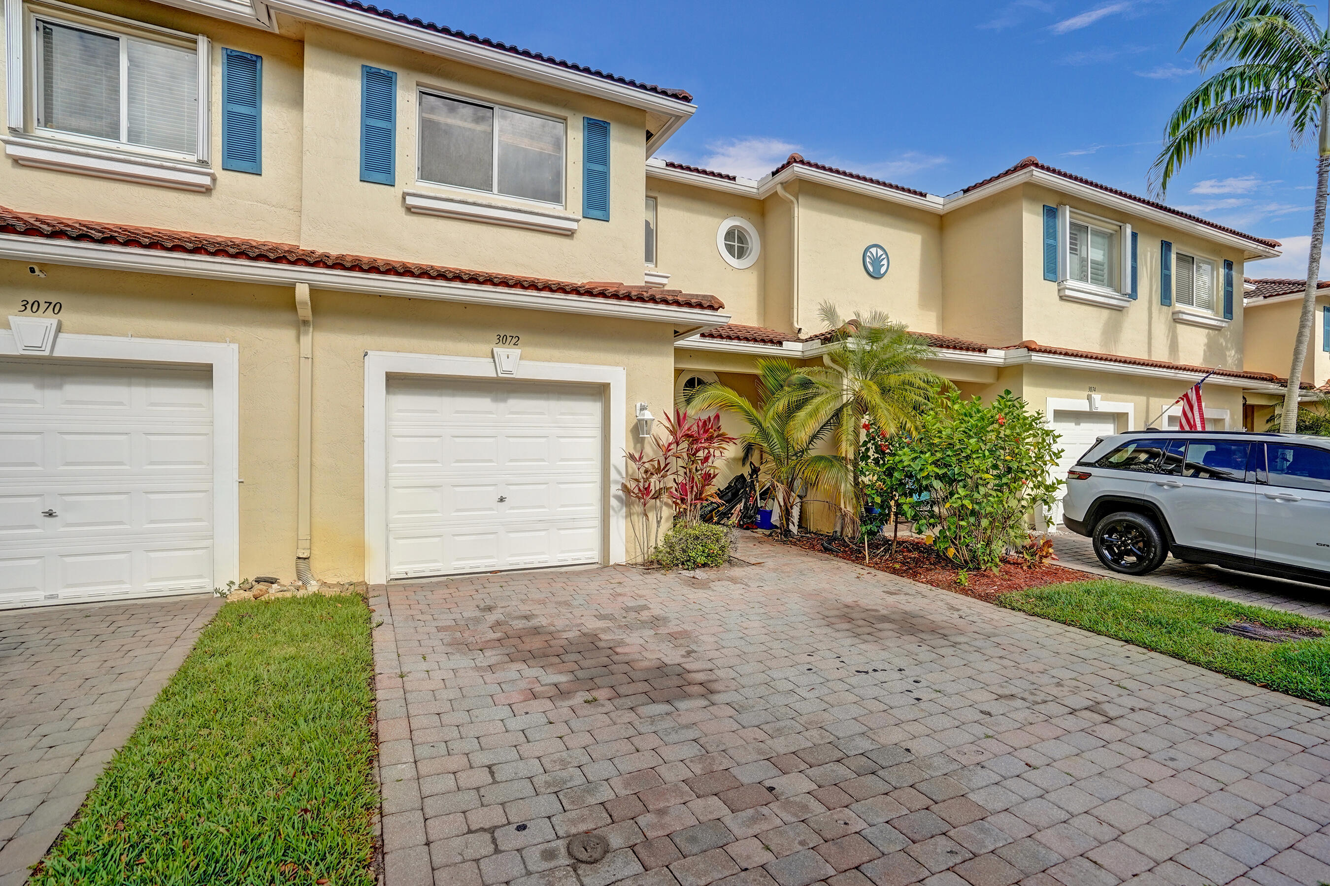 3072 North Evergreen Circle Boynton Beach, FL 33426 - Photo 3 of 55 a front view of a house with a yard and garage