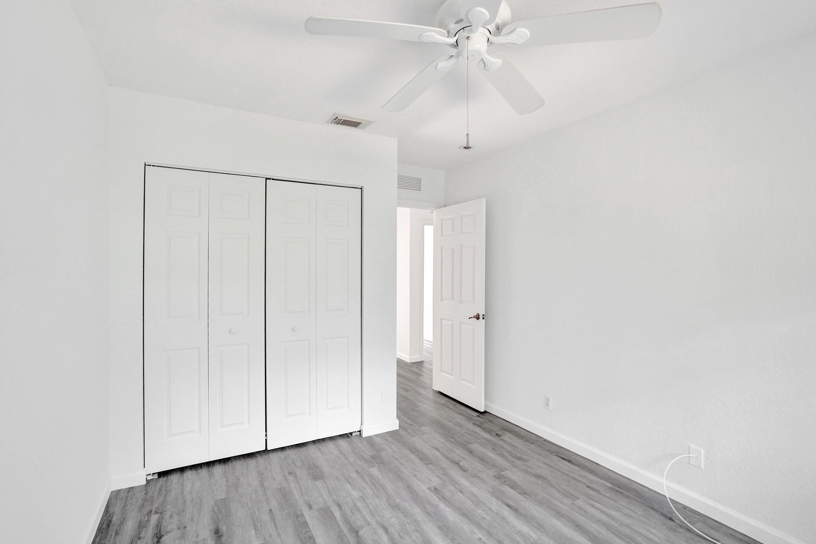 3072 North Evergreen Circle Boynton Beach, FL 33426 - Photo 34 of 55 a view of an empty room with wooden floor
