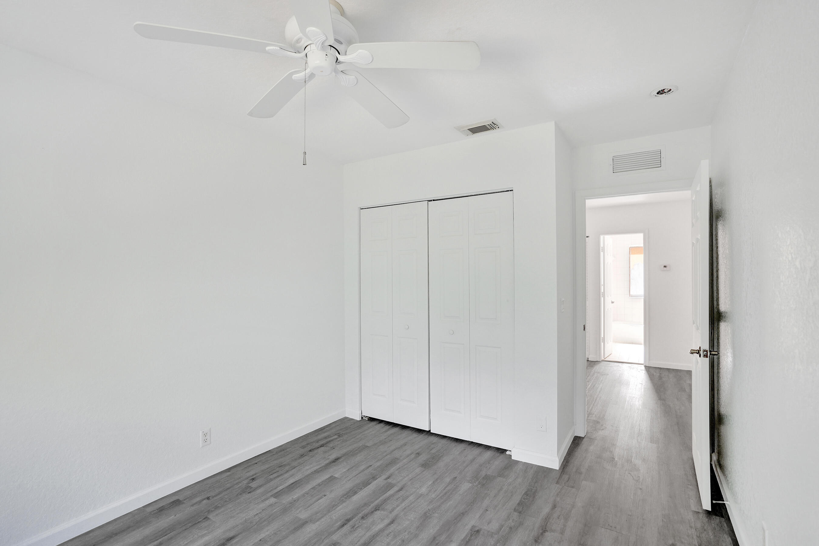 3072 North Evergreen Circle Boynton Beach, FL 33426 - Photo 35 of 55 a view of an empty room with wooden floor