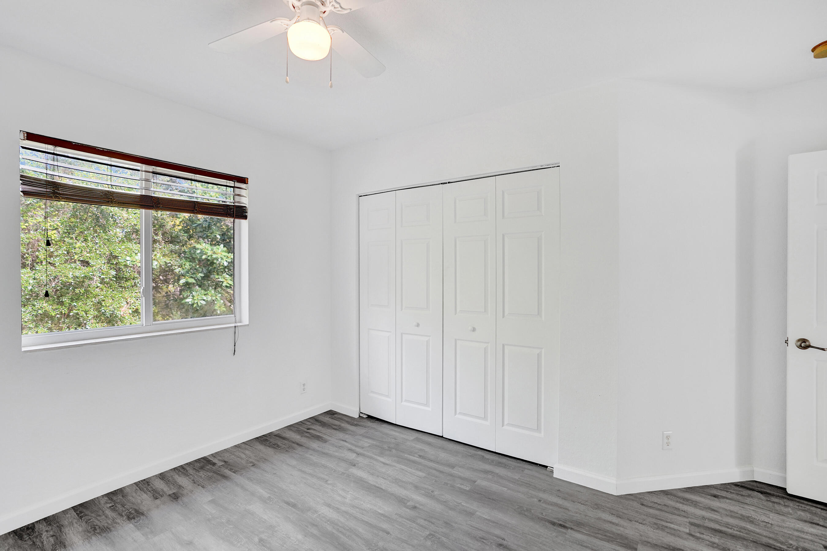 3072 North Evergreen Circle Boynton Beach, FL 33426 - Photo 37 of 55 an empty room with wooden floor and windows