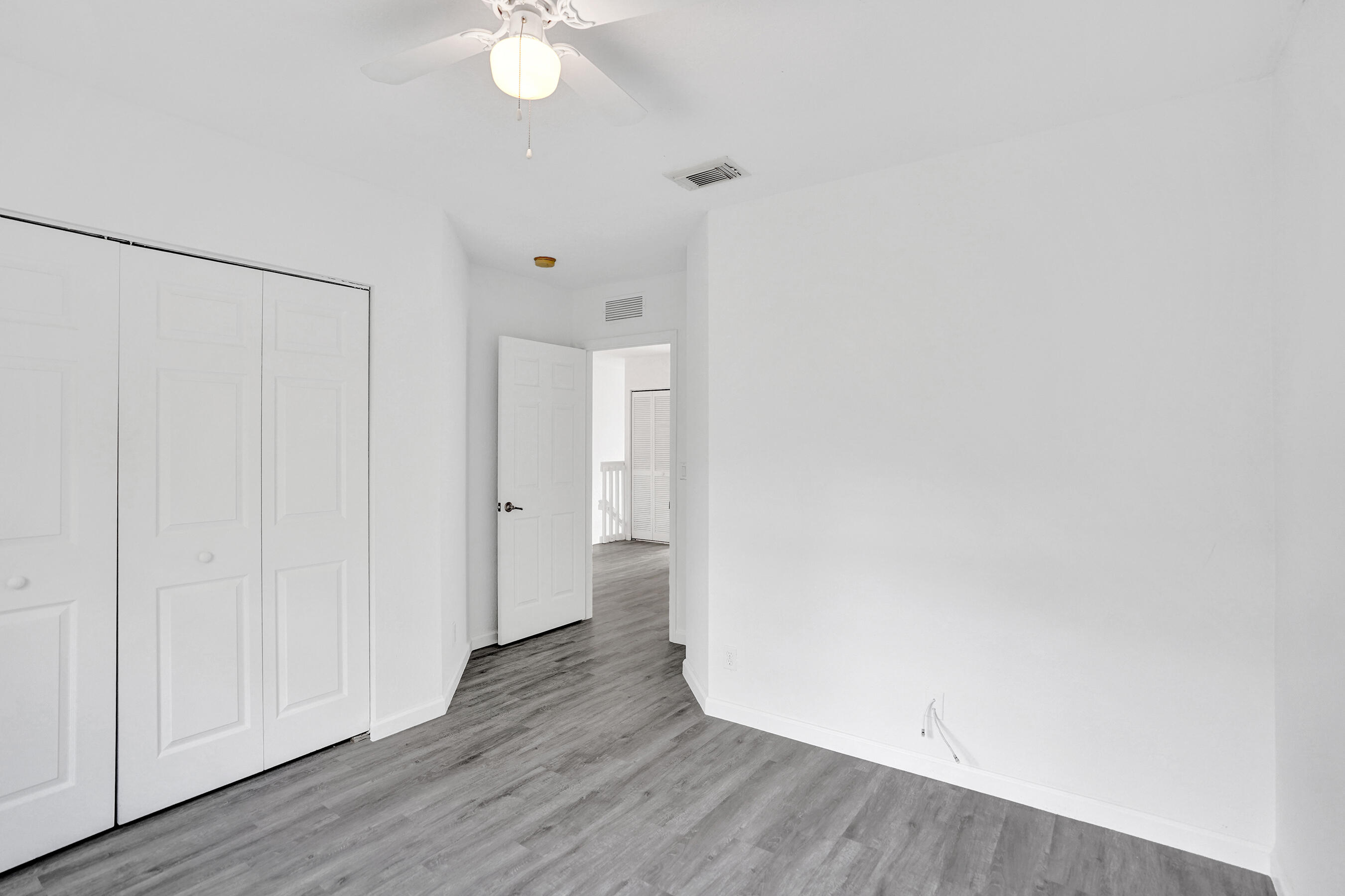 3072 North Evergreen Circle Boynton Beach, FL 33426 - Photo 38 of 55 a view of an empty room with wooden floor