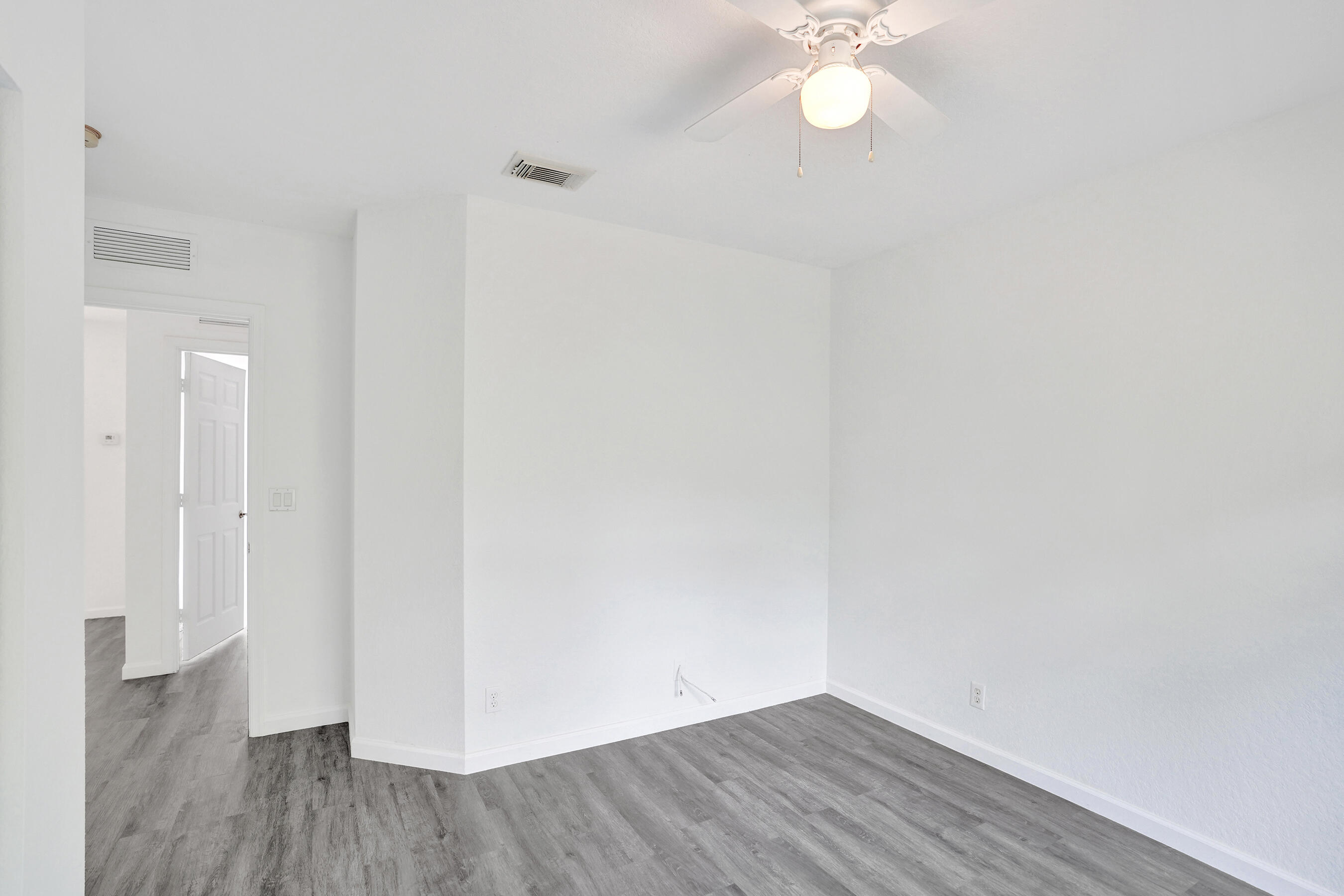 3072 North Evergreen Circle Boynton Beach, FL 33426 - Photo 39 of 55 a view of a room with wooden floor and a ceiling fan