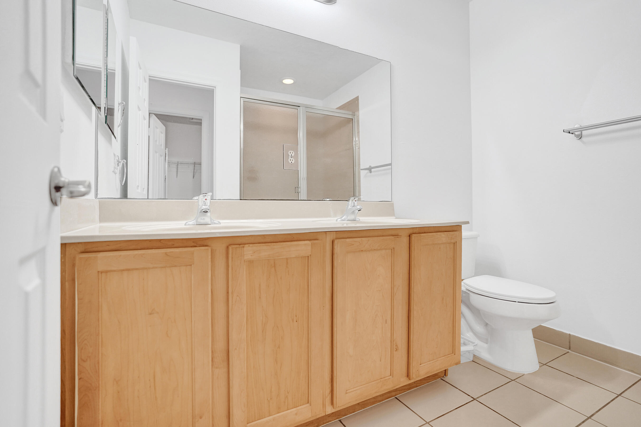 3072 North Evergreen Circle Boynton Beach, FL 33426 - Photo 40 of 55 a bathroom with a sink a toilet and a mirror