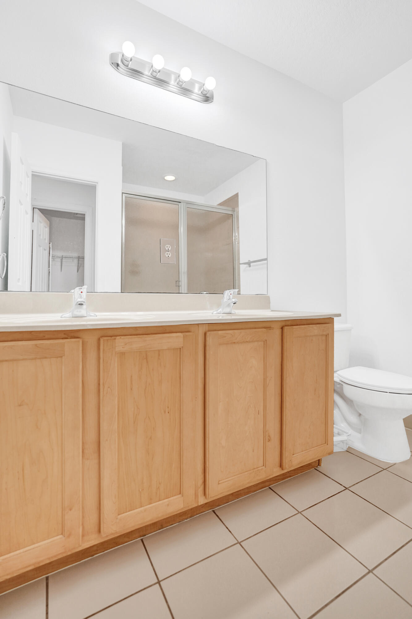 3072 North Evergreen Circle Boynton Beach, FL 33426 - Photo 41 of 55 a bathroom with a sink a toilet and a mirror