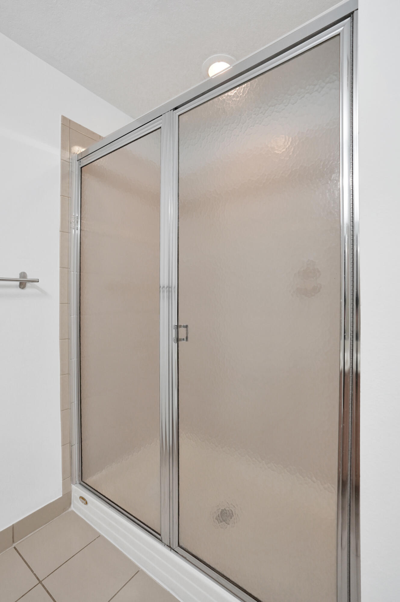 3072 North Evergreen Circle Boynton Beach, FL 33426 - Photo 43 of 55 a bathroom with a glass shower door