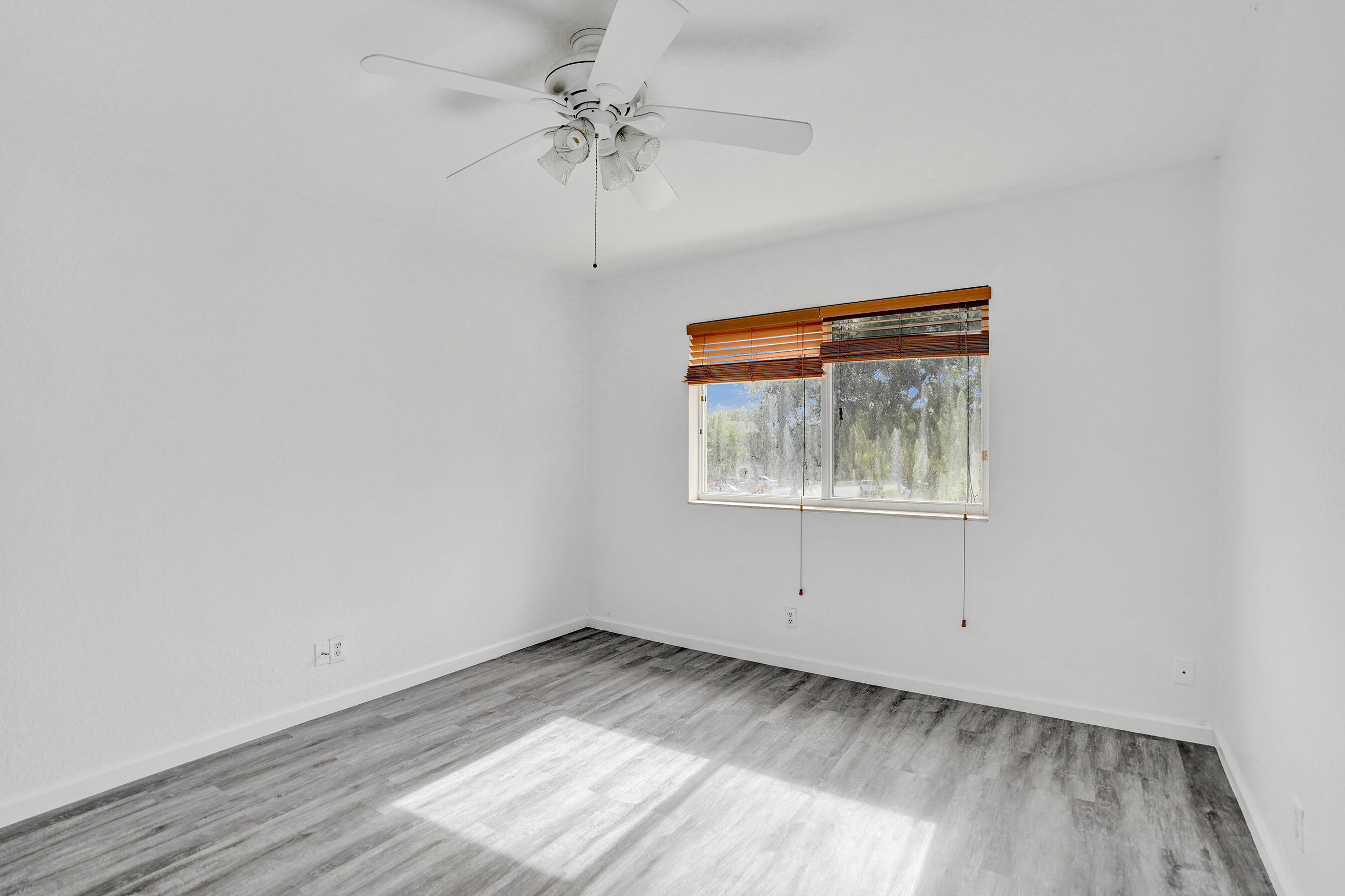 3072 North Evergreen Circle Boynton Beach, FL 33426 - Photo 46 of 55 an empty room with a window and a ceiling fan