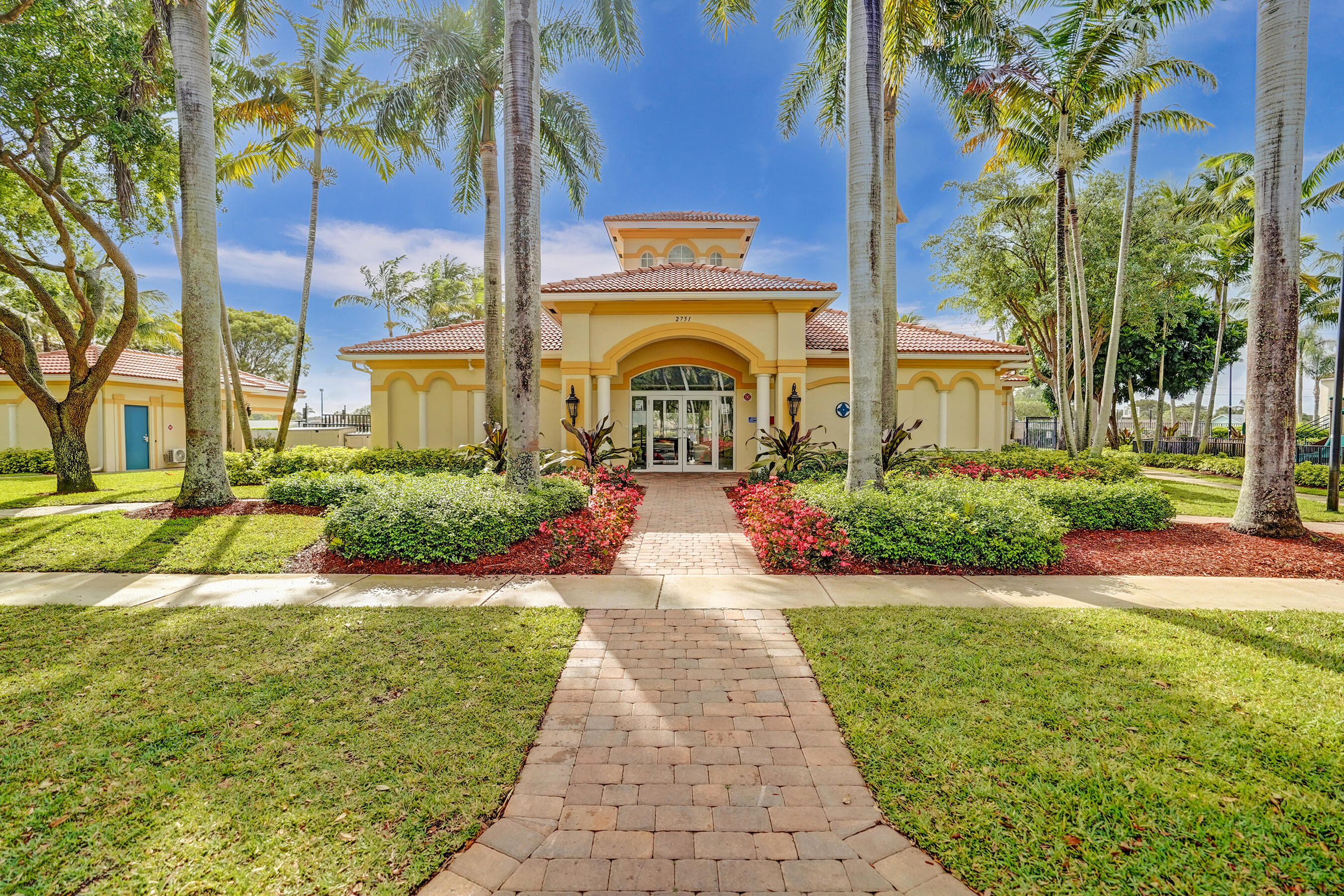 3072 North Evergreen Circle Boynton Beach, FL 33426 - Photo 51 of 55 a front view of a house with a garden