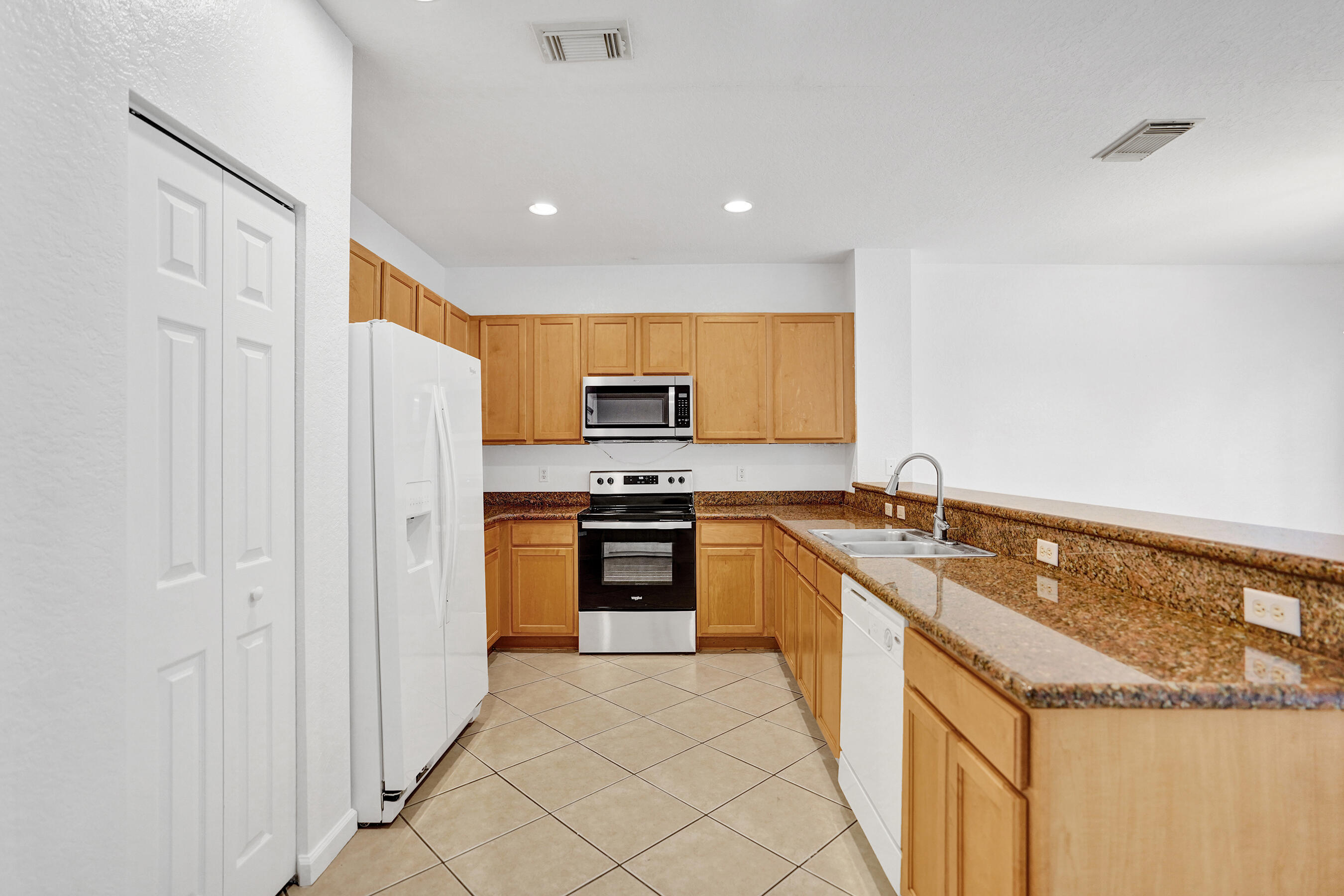 3072 North Evergreen Circle Boynton Beach, FL 33426 - Photo 7 of 55 a modern kitchen with stainless steel appliances granite countertop a refrigerator and a sink