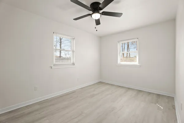 wooden floor in an empty room with a window