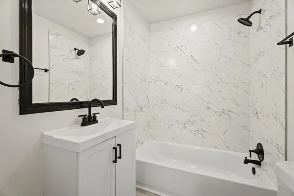 a bathroom with a sink a toilet and a bathtub
