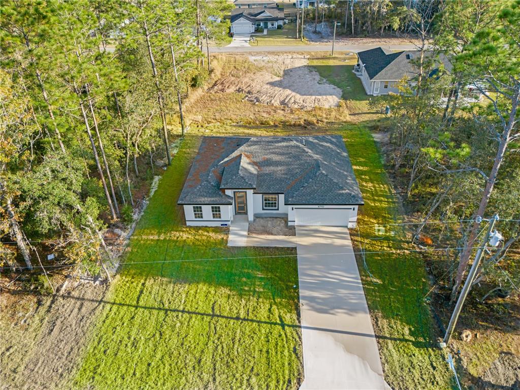 6770 Southwest 149th Lane Ocala, FL 34473 - Photo 1 of 1 a view of swimming pool with a garden
