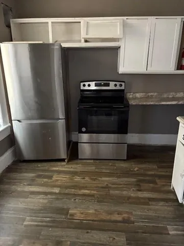 a kitchen with kitchen island a stove and a refrigerator