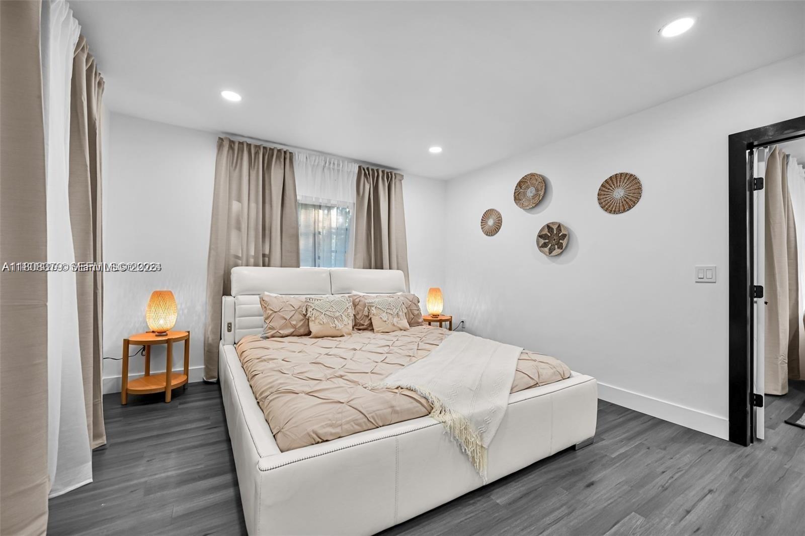7335 Southwest 104th Street Pinecrest, FL 33156 - Photo 13 of 36 a bedroom with a bed and a window