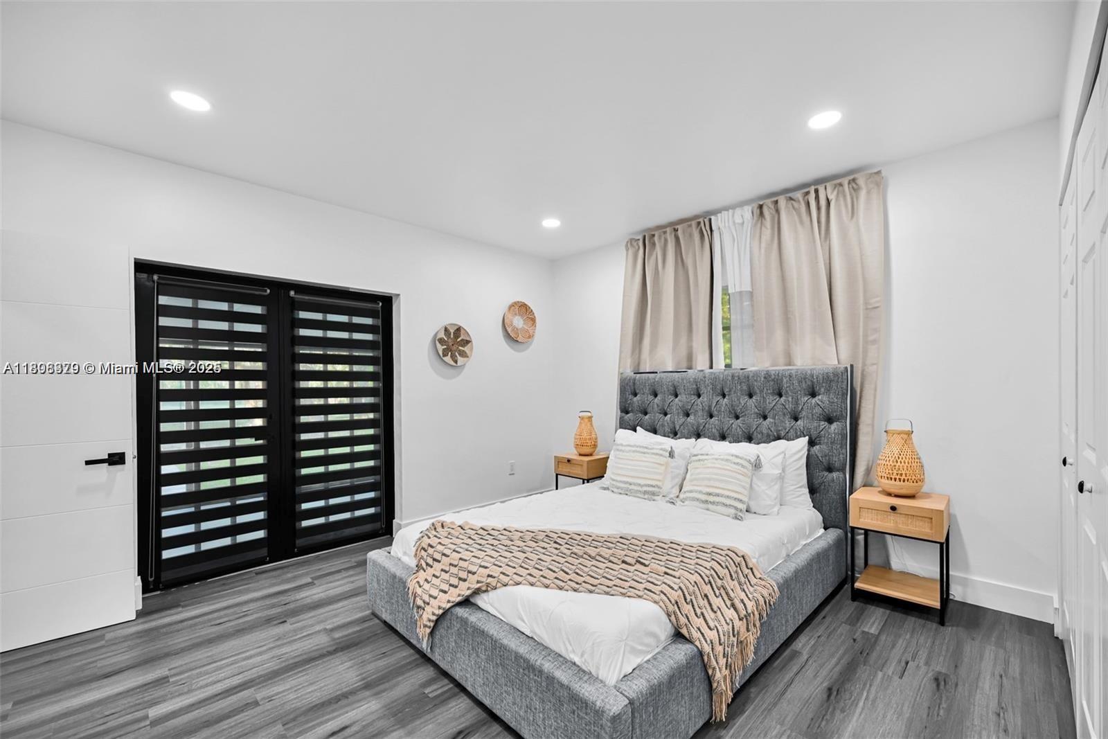 7335 Southwest 104th Street Pinecrest, FL 33156 - Photo 14 of 36 a bedroom with a bed and a window