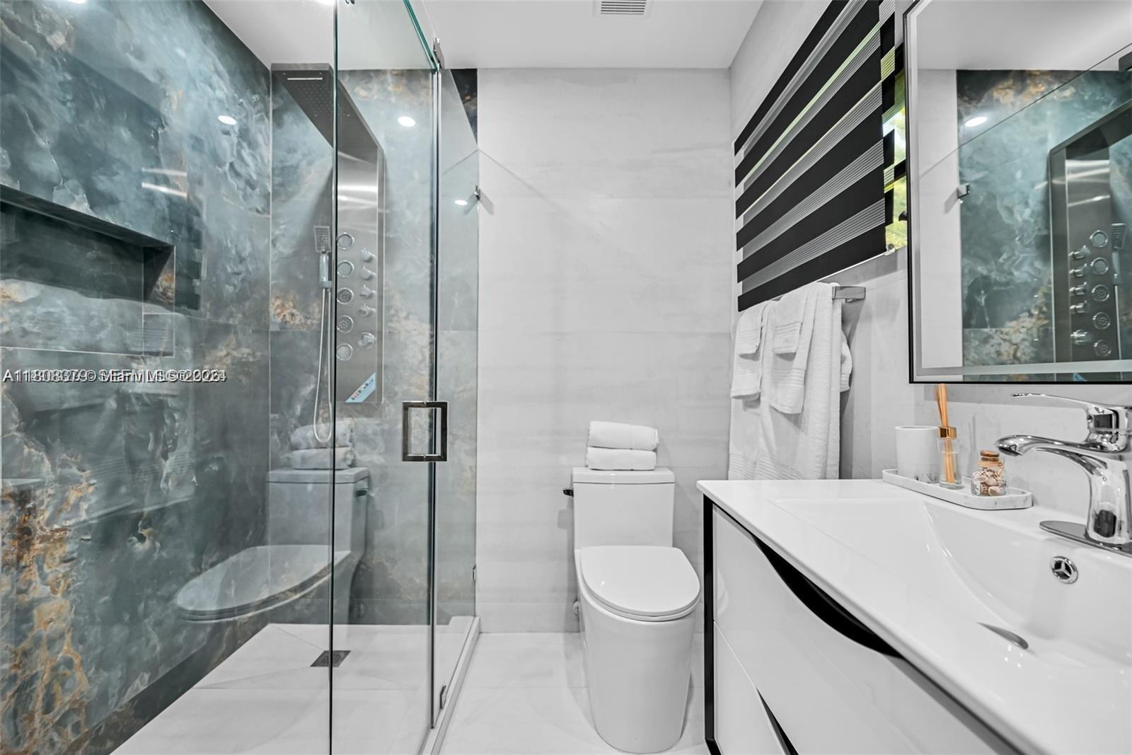 7335 Southwest 104th Street Pinecrest, FL 33156 - Photo 14 of 36 a bathroom with a sink a toilet and shower