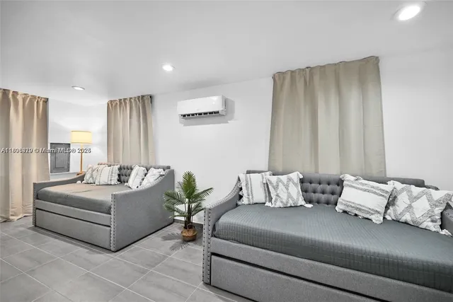 a living room with furniture and a large mirror