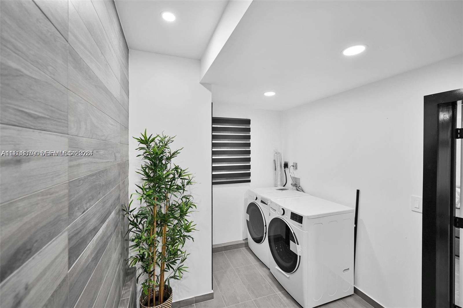 7335 Southwest 104th Street Pinecrest, FL 33156 - Photo 17 of 36 a utility room with dryer and washer