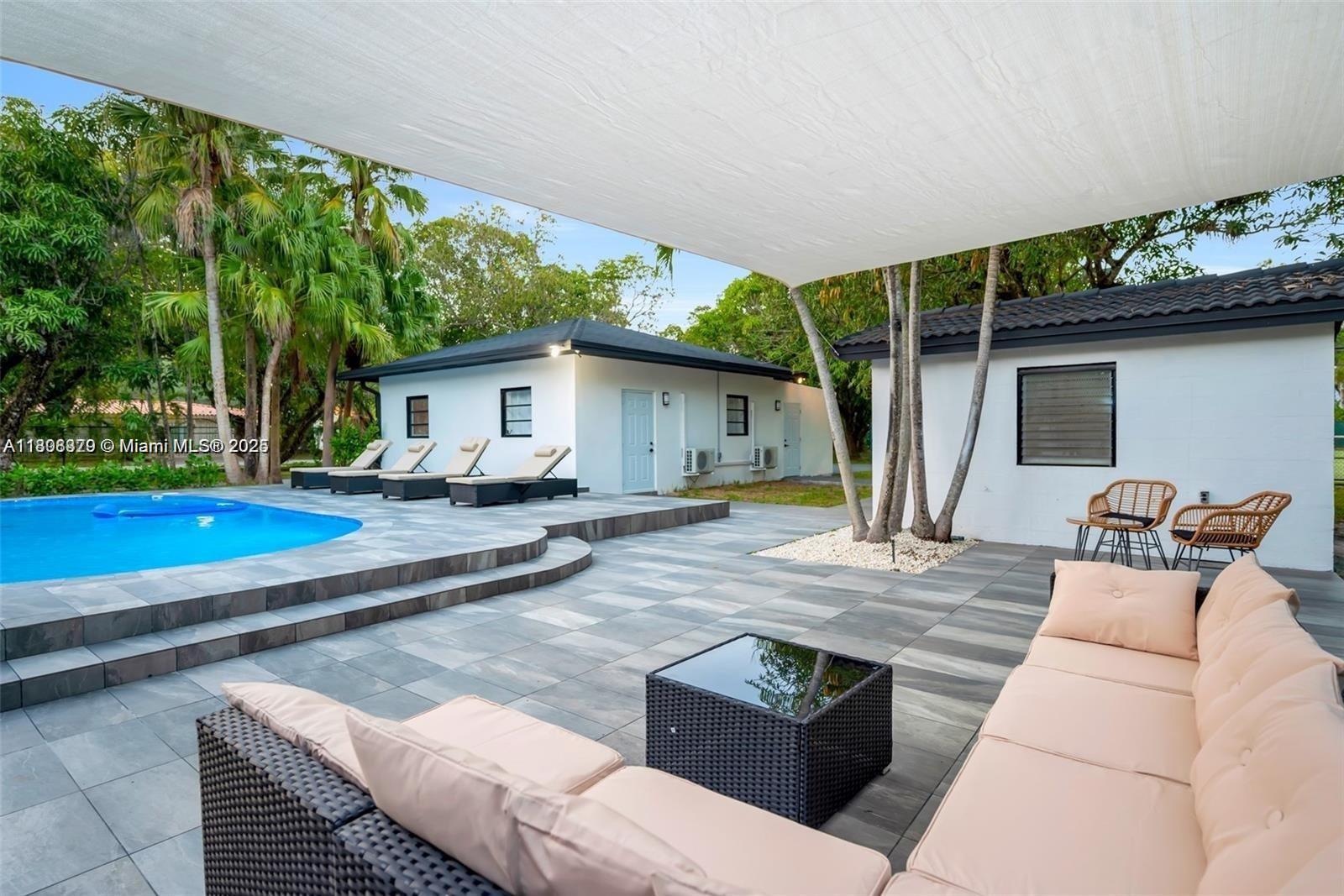 7335 Southwest 104th Street Pinecrest, FL 33156 - Photo 23 of 36 a view of a house with backyard and sitting area