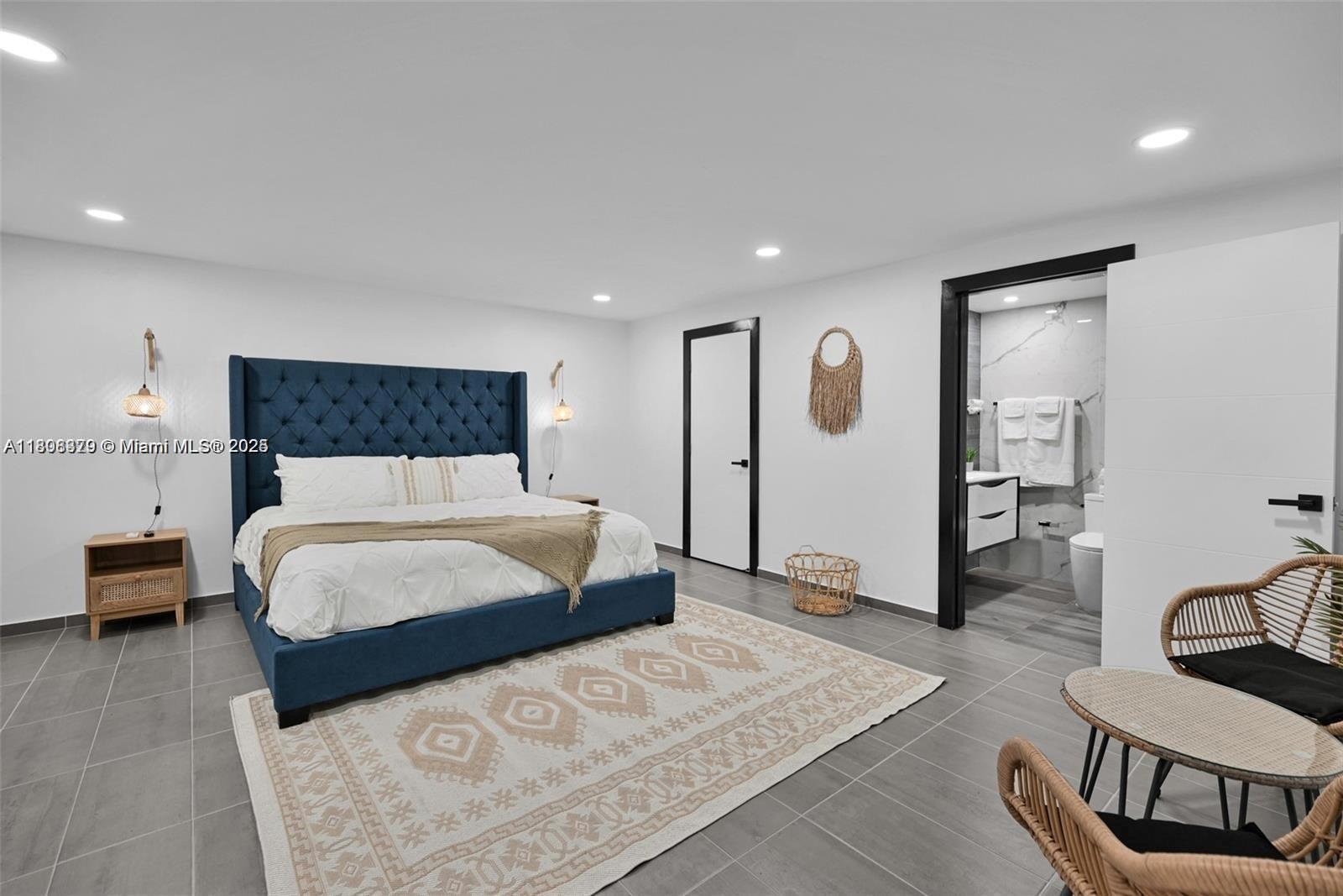 7335 Southwest 104th Street Pinecrest, FL 33156 - Photo 26 of 36 a bedroom with a large bed and a couch