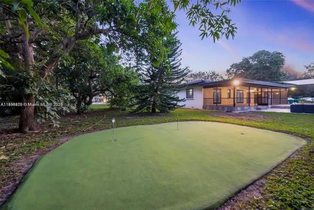 a view of an house with swimming pool yard and outdoor seating