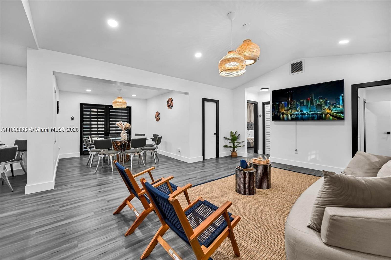 7335 Southwest 104th Street Pinecrest, FL 33156 - Photo 5 of 36 a living room with furniture and a flat screen tv