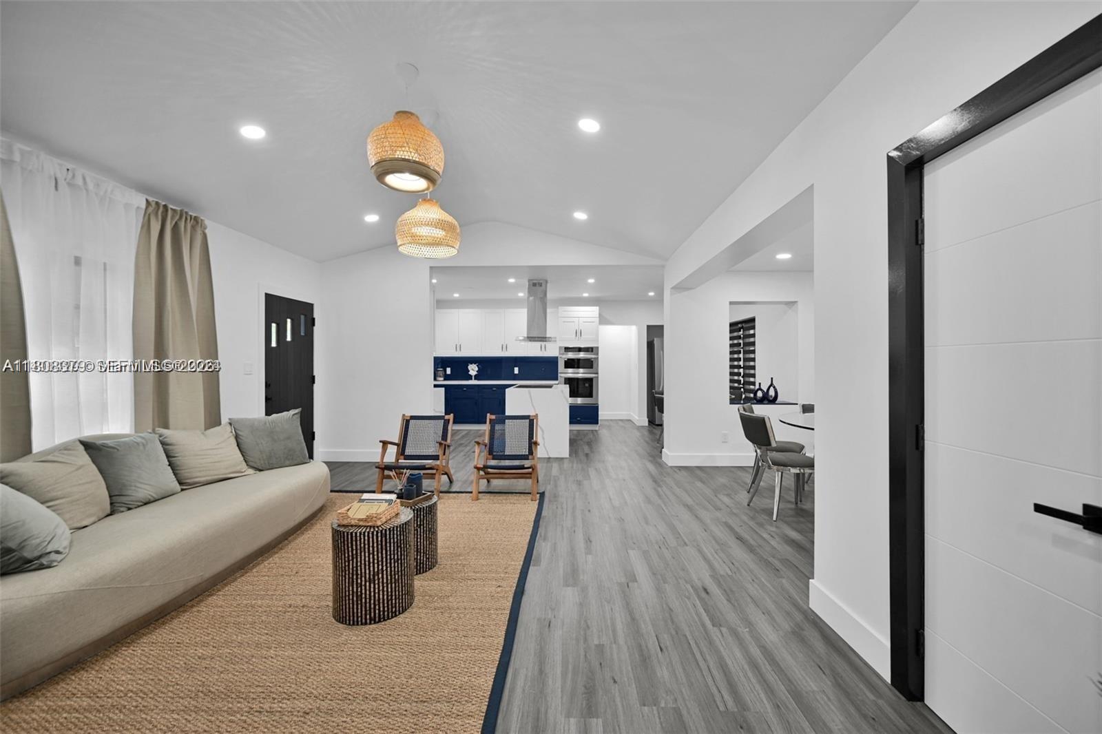 7335 Southwest 104th Street Pinecrest, FL 33156 - Photo 7 of 36 a living room with furniture and wooden floor