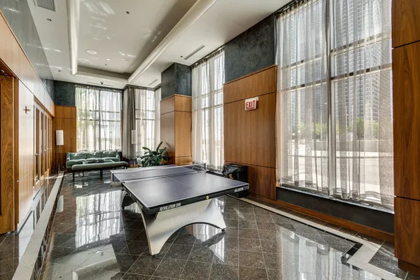 a living room with furniture and large windows