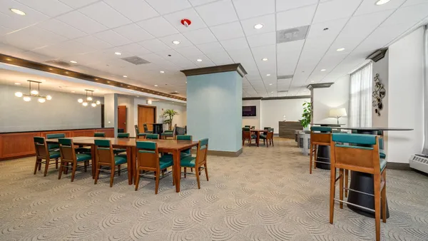 a row of palm trees in front of house