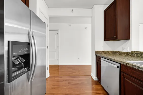 a kitchen with a refrigerator and a stove