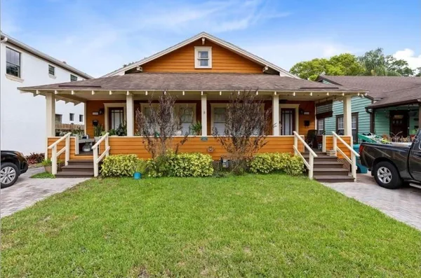 a view of a house with a yard porch and sitting area