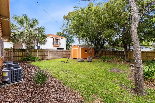 a view of backyard with outdoor seating and green space