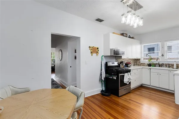 a kitchen with stainless steel appliances granite countertop a refrigerator and a stove top oven