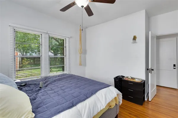a bedroom with a bed and wooden floor